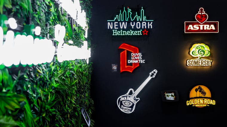 LED Neon signs of beverage brands on a black wall