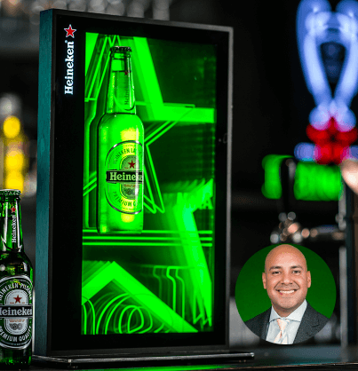 Heineken beer bottle inside a fridge made with green LED neons and picture of Marketing Activation Manager at The Heineken Company 